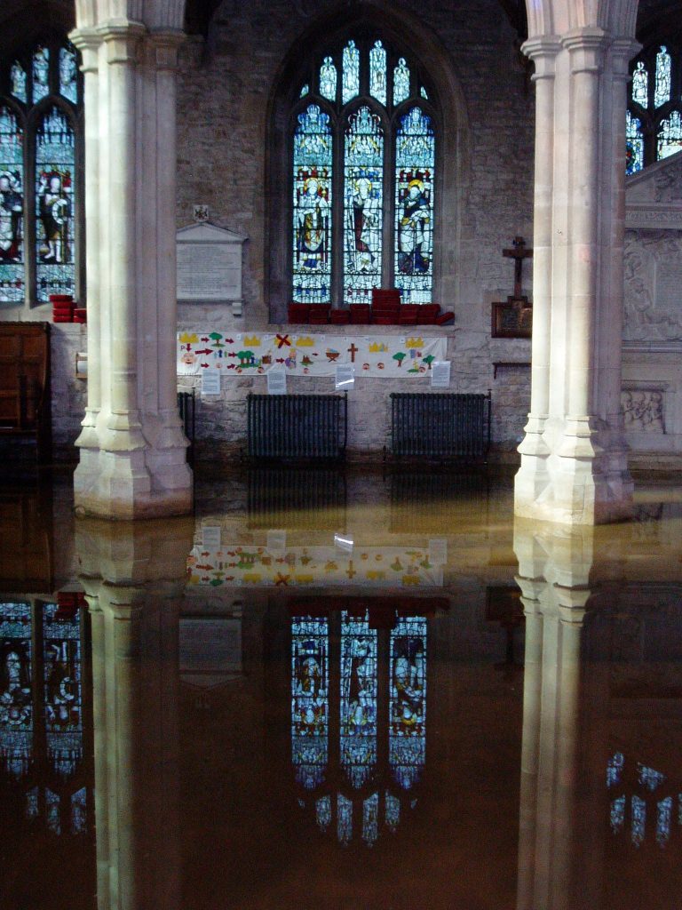Standing water inside St John the Baptist Church (Burford Church) in Oxfordshire.