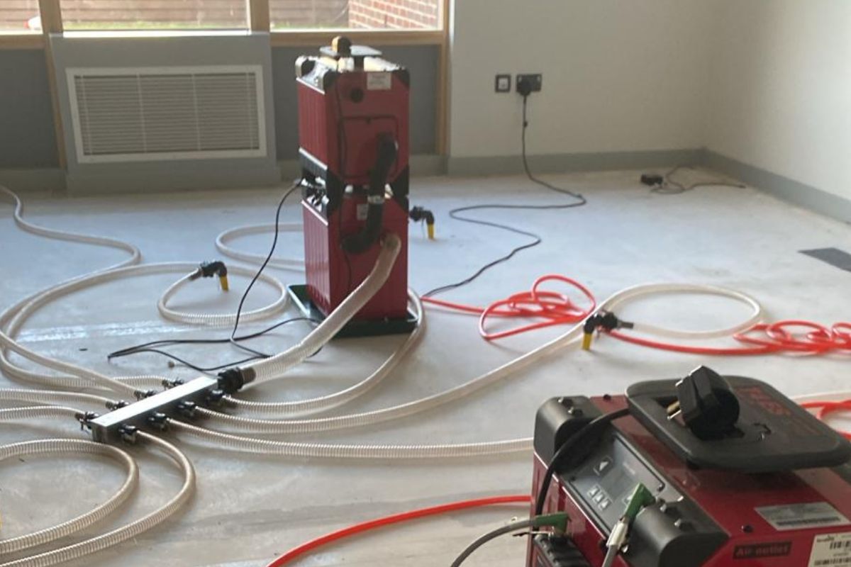 Two pressure dryers standing in the middle of a room to help illustrate Vinci Response's pressure drying services.