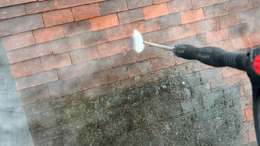 BDMA- accredited technicians from Vinci Response cleaning stone roof tiles.