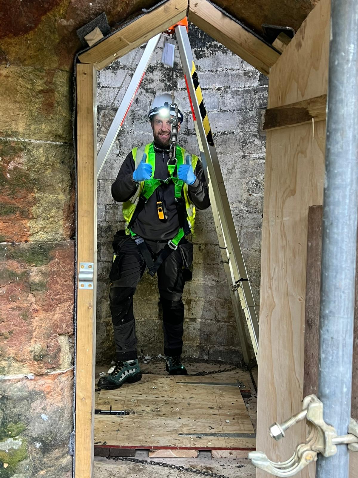 A Vinci Response technician gives the thumbs up before descending a tunnel at Amberley Castle to remove guano.